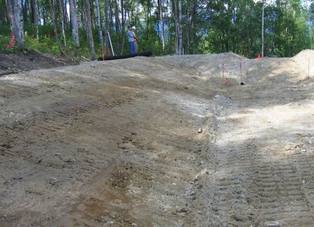 Hailing dirt with an excavator and offload truck